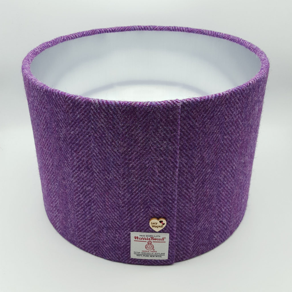 25cm D purple herringbone Harris Tweed with label beside the seam and brushed silver lining