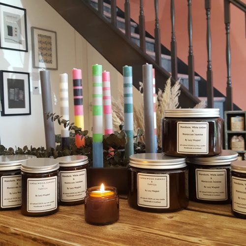 A selection of scented candles and striped dinner candles